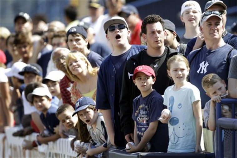 FILE-   This Tuesday, Feb. 22, 2011 file photo shows fans as they watch the New York Yankees during batting practice at a baseball spring training workout at Steinbrenner Field in Tampa, Fla.  Fans have been traveling to Central and South Florida for decades to get a glimpse of veteran stars and new prospects alike during spring training.    (AP Photo/Charlie Neibergall, file)